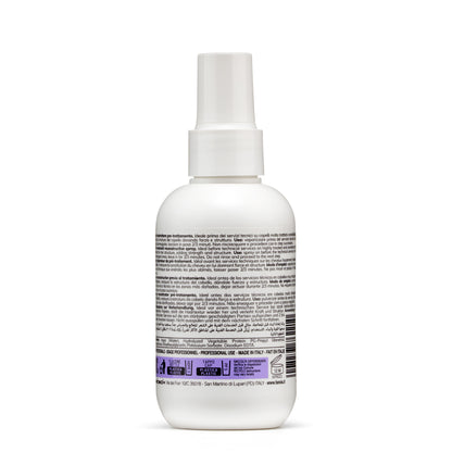 White spray bottle with multilingual hair treatment label, made in Italy for professional use